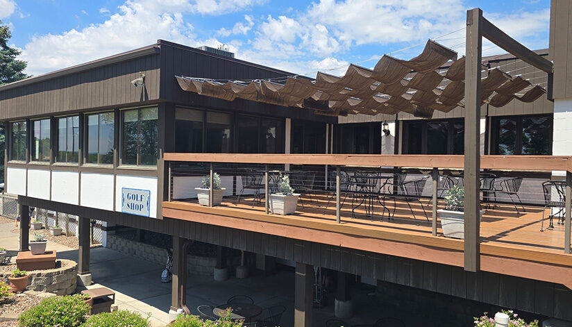 Drugan’s Castle Mound golf shop features a spacious patio with sunshade panels and outdoor seating overlooking the scenic course.