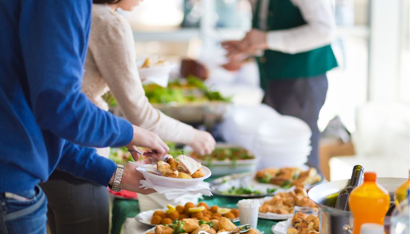 Guests help themselves to a buffet of assorted dishes and drinks during an event at Drugan’s Castle Mound in Holmen, Wisconsin.