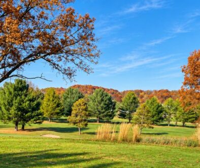 Fall view of the golf course at Drugan’s Castle Mound in Wisconsin with colorful autumn trees and Hole 8.