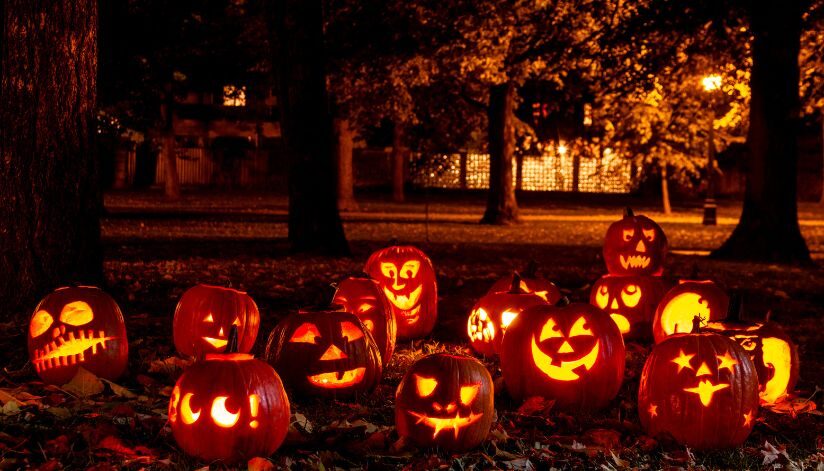 Carved pumpkins glow along the wooded paths, lighting the way for Halloween trick-or-treaters.